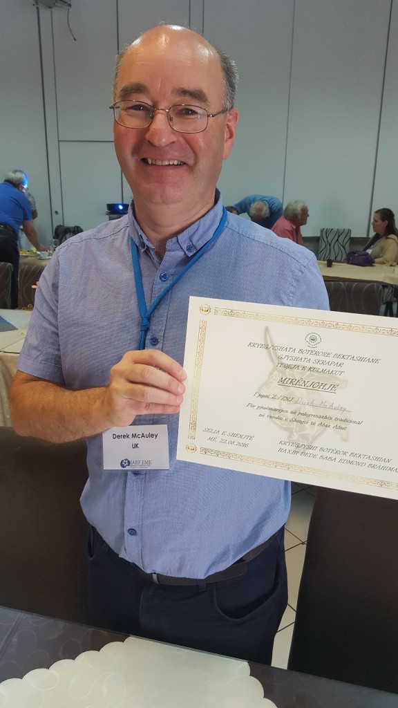 Derek McAuley, EME Chair, being presented with a certificate of friendship from the Bektashi.