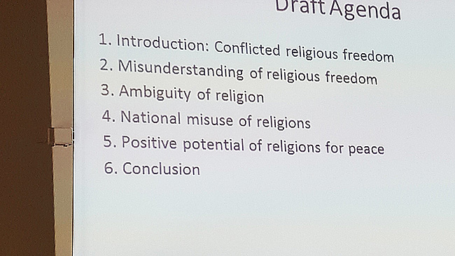 Projected lecture agenda covering religious freedom, misunderstanding, national misuse of religion and its potential for peace.