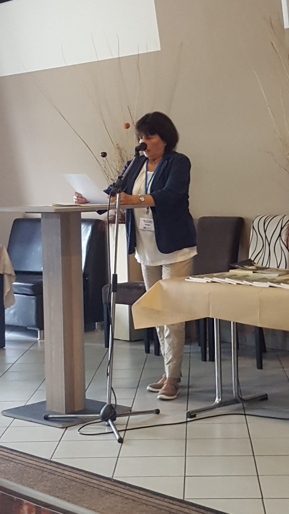 A participant reading from a lectern during the Tetovo conference.
