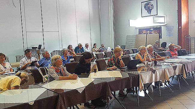 Participants seated around tables during the Tetovo conference.