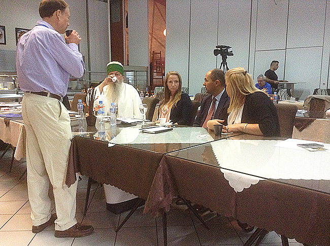 A speaker addressing conference participants, including Dedebaba Edmond Brahimaj.