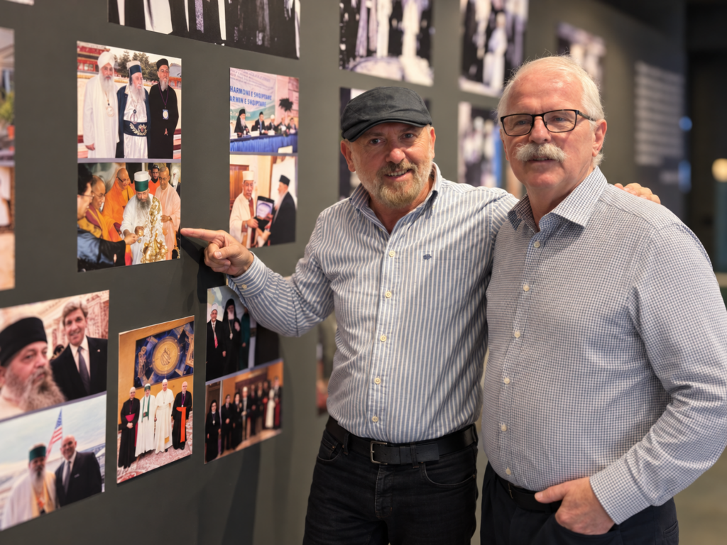 Arben Sulejmani points to a historic photograph on a museum display at the Bektashi World Headquarters.